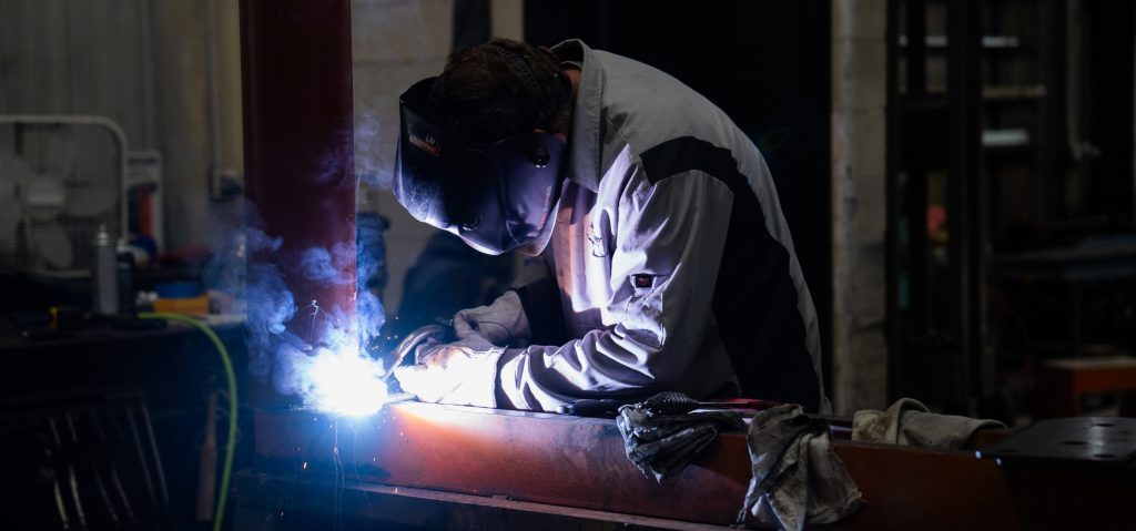 welder welding a corner metal piece
