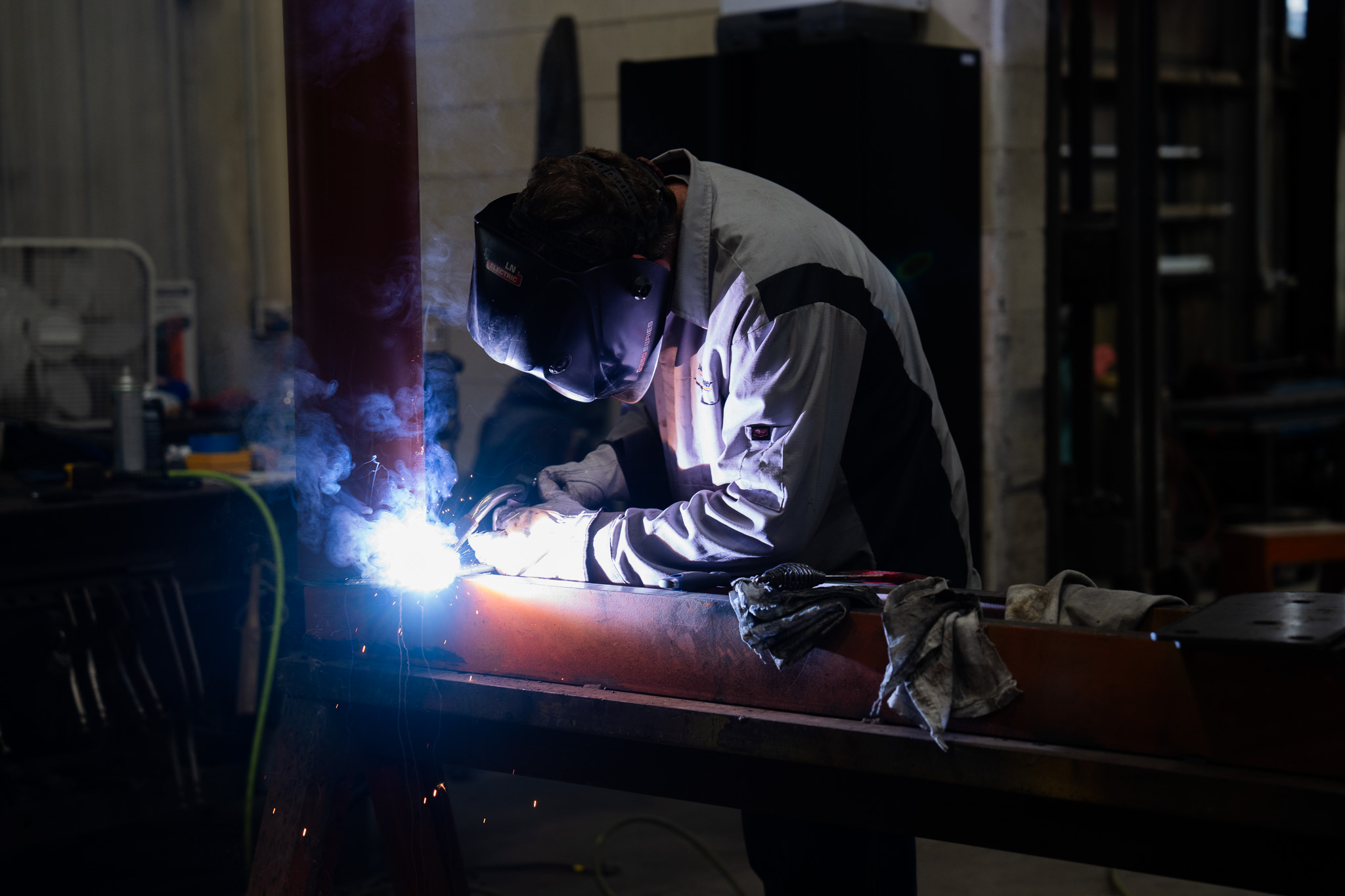 welder welding a corner metal piece
